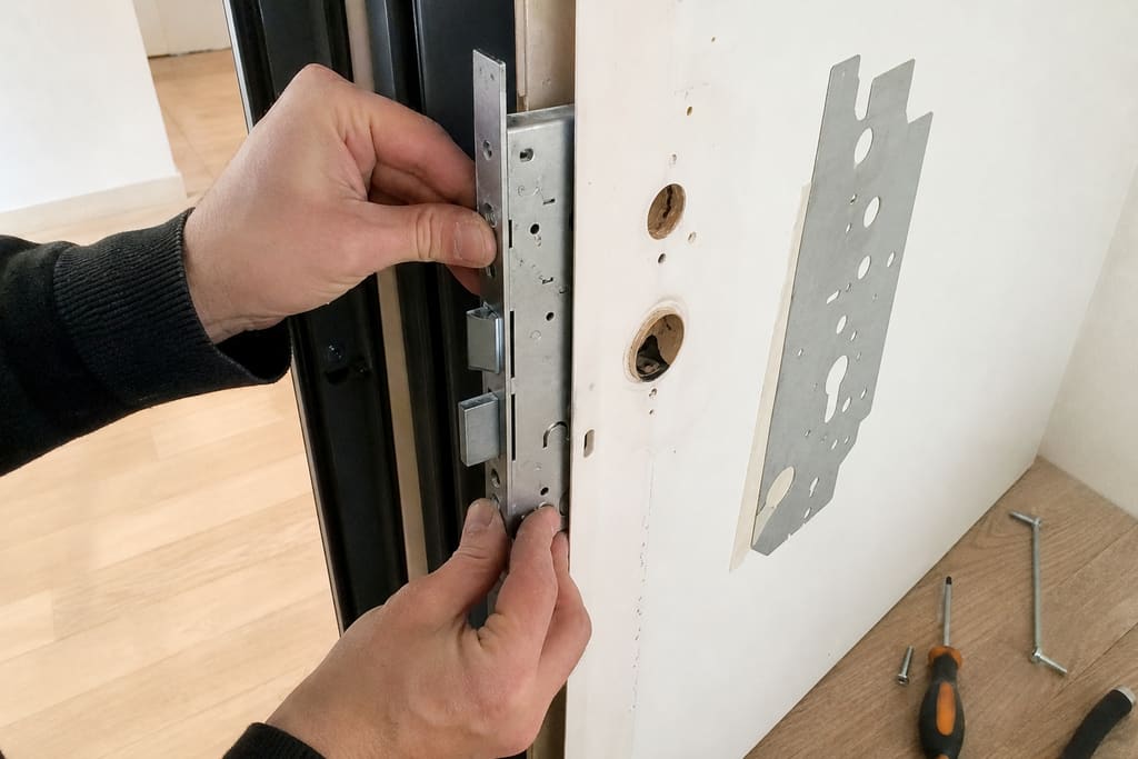 mains installant serrure multipoints boîtier et pênes alignés
